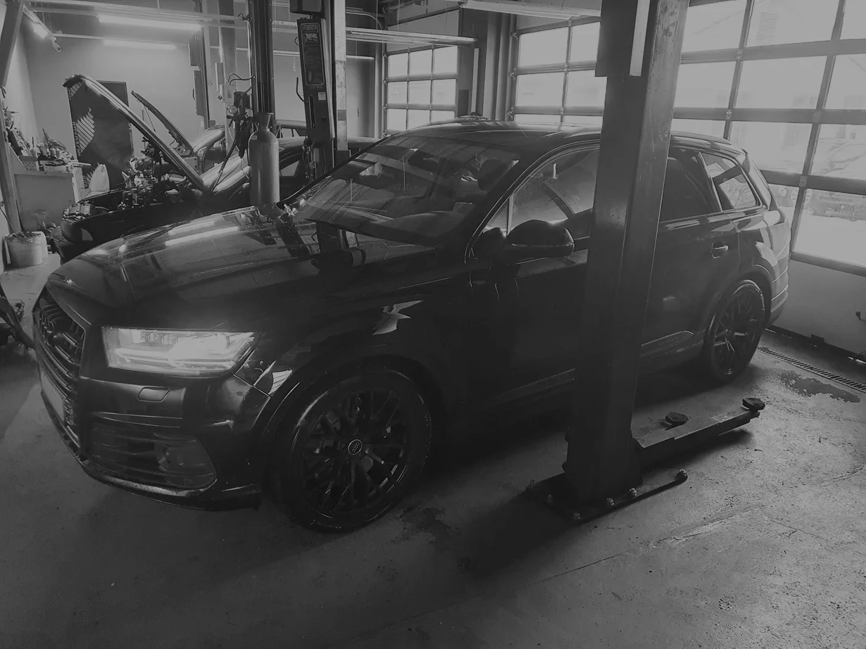 Audi Q3 ar atvērtu pārsegu autoservisā